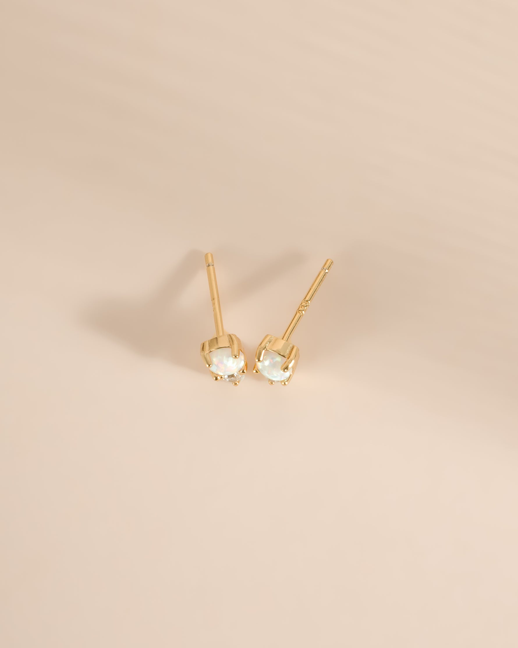 Gold top-view of Sami Jewels opal and cubic zirconia stud earrings showcasing their sparkling gemstones and elegant design.