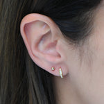 Gold CZ Baguette Huggie Earrings by Sami Jewels featuring sparkling rectangular stones and sleek hoop design.