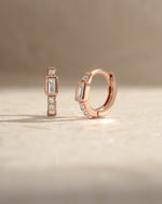 Rose gold CZ baguette huggie earrings by Sami Jewels, featuring sparkling rectangular-cut gemstones in a stylish hoop design.
