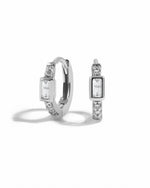 Sterling silver CZ Baguette Huggie Earrings by Sami Jewels with sparkling rectangular stones on a white background.