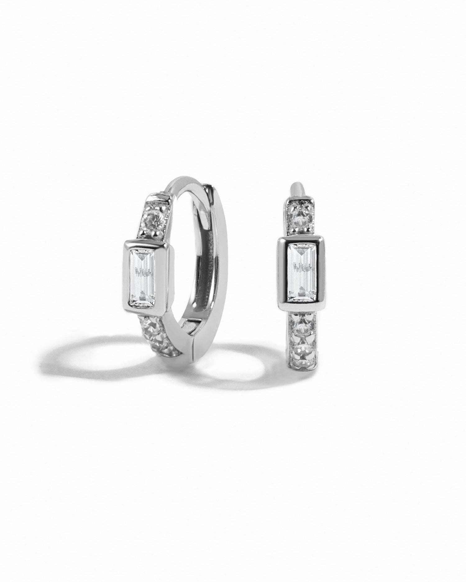 Sterling silver CZ Baguette Huggie Earrings by Sami Jewels with sparkling rectangular stones on a white background.