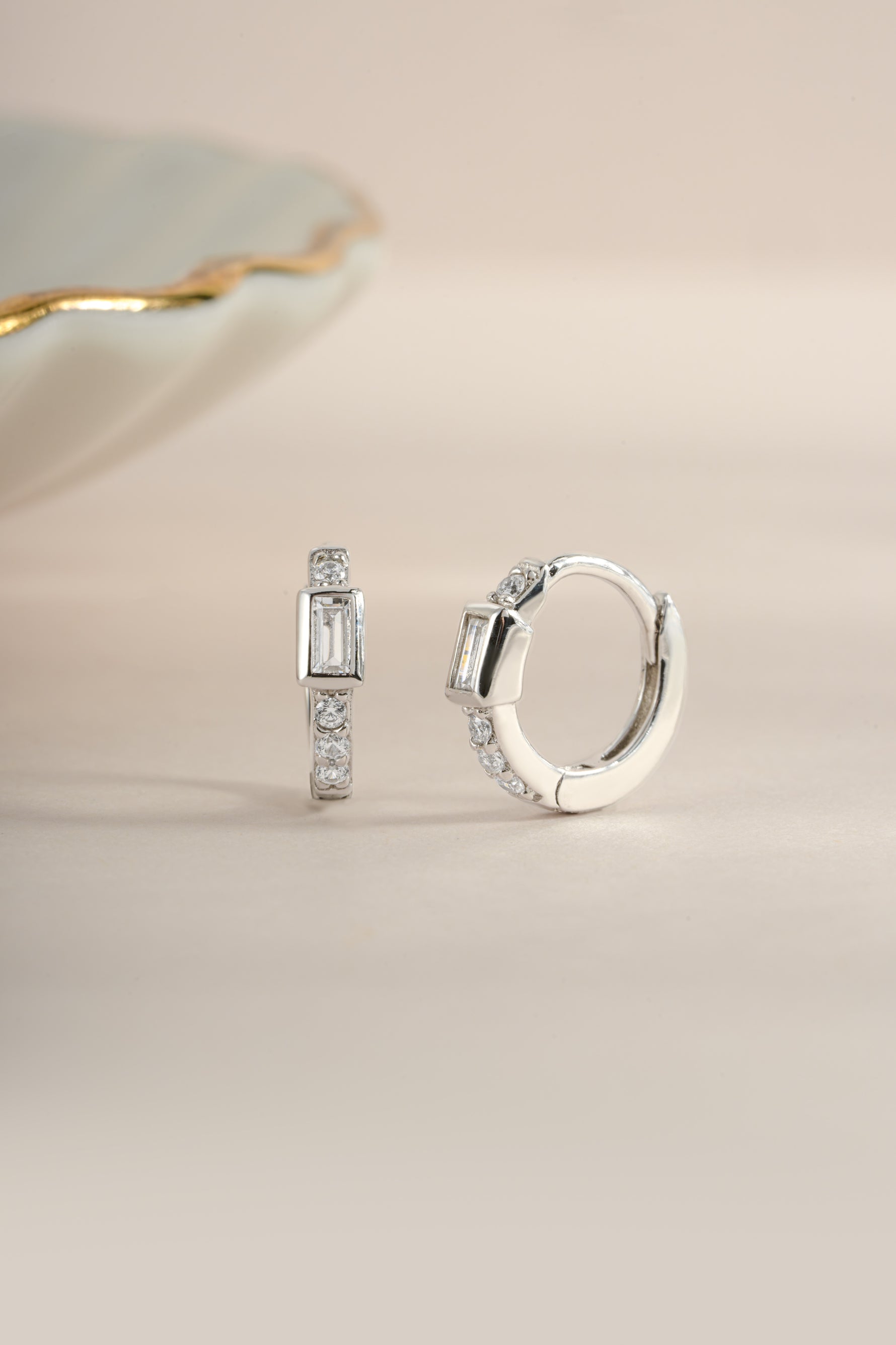 Sterling silver CZ baguette huggie earrings by Sami Jewels, featuring sparkling rectangular-cut cubic zirconia in a close-up view.