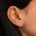 model wearing silver stud earrings