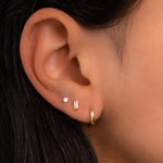 model wearing gold dainty earrings