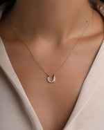 Gold horseshoe pendant necklace from Sami Jewels featuring sparkling cubic zirconia stones, jewelry accessory for good luck.