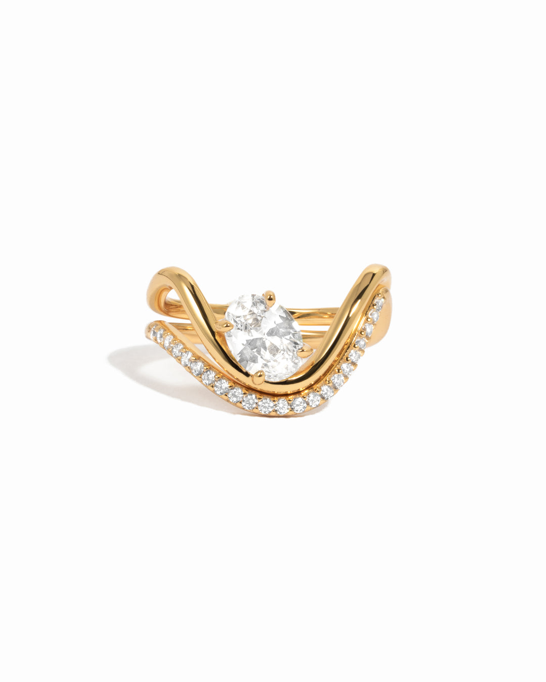 White background image of gold cz oval wave engagement ring set.