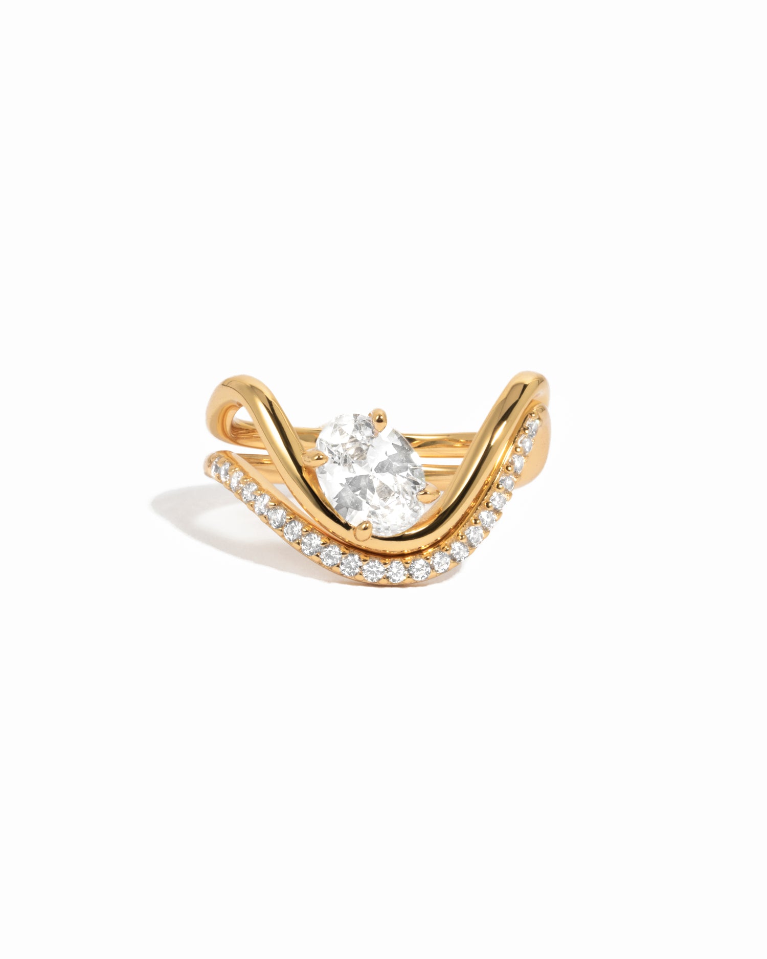 White background image of gold cz oval wave engagement ring set.