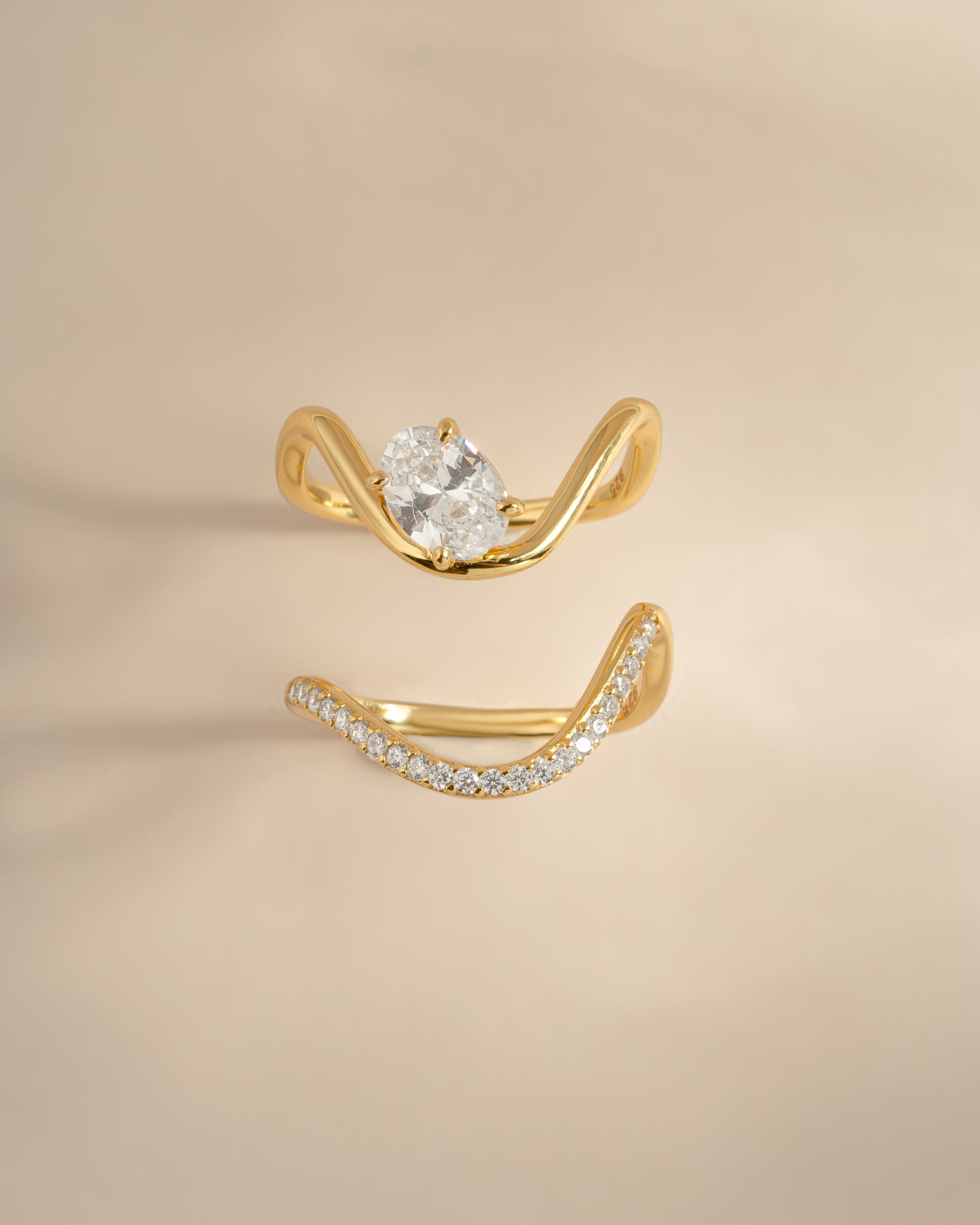 Front view of gold cz wavy engagement ring set with pavé band.