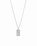 A silver-toned rectangular pendant necklace with a halo border and a palm tree motif, suspended on a delicate chain against a plain white background.