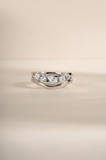 Close-up image of silver chevron stacking ring set featuring 5 CZ stones.