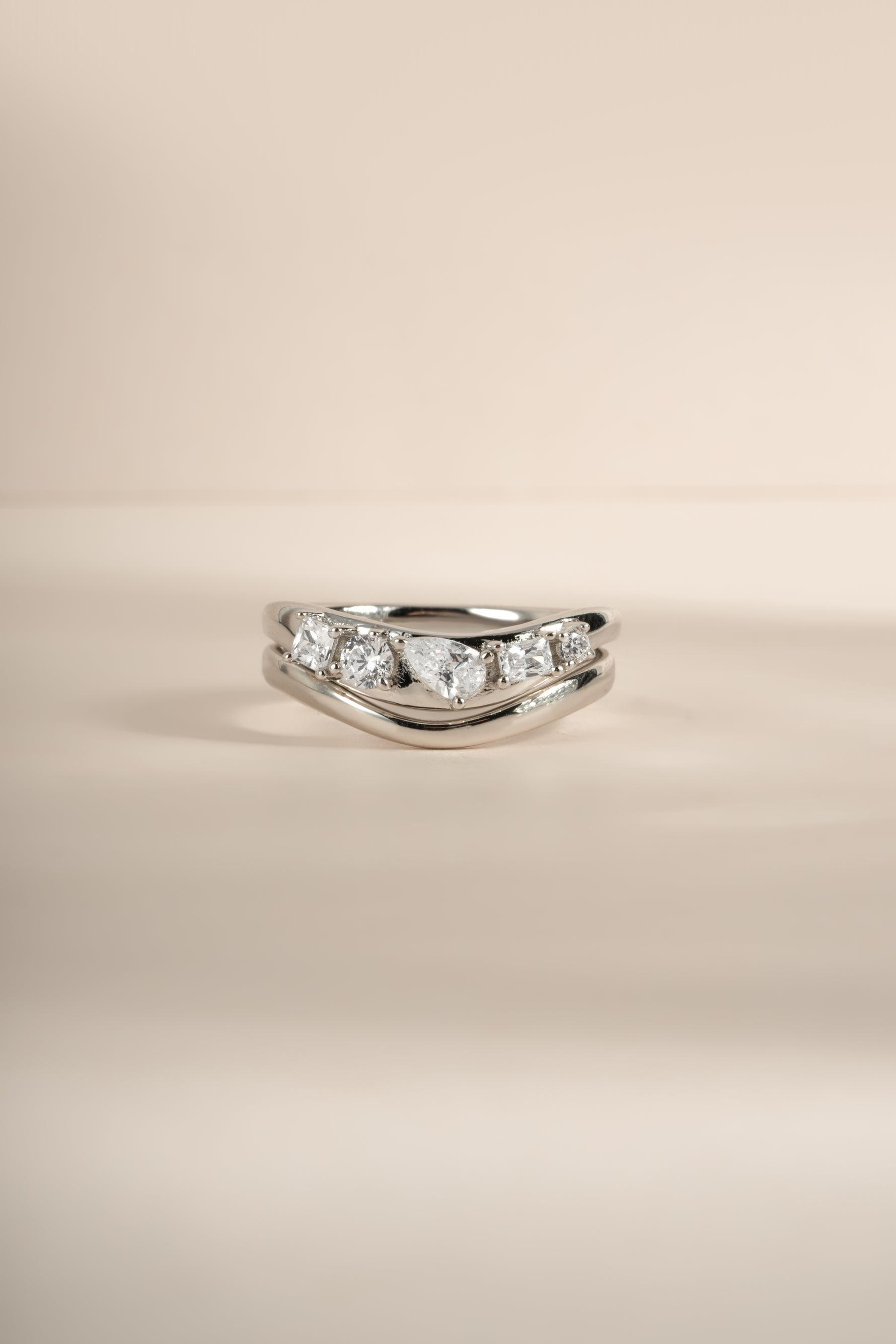 Close-up image of silver chevron stacking ring set featuring 5 CZ stones.