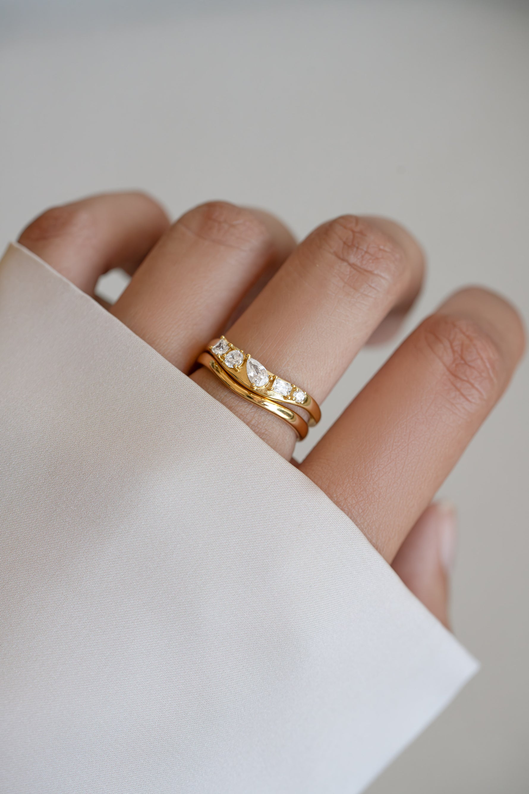 Model wearing gold chevron ring set featuring 5 CZ stones.