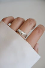 Model wearing silver chevron wavy ring set featuring 5 CZ stones.