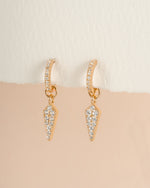Gold Dagger Charm Huggie Earrings by Sami Jewels, close-up view showing detailed design and hoop style jewelry.