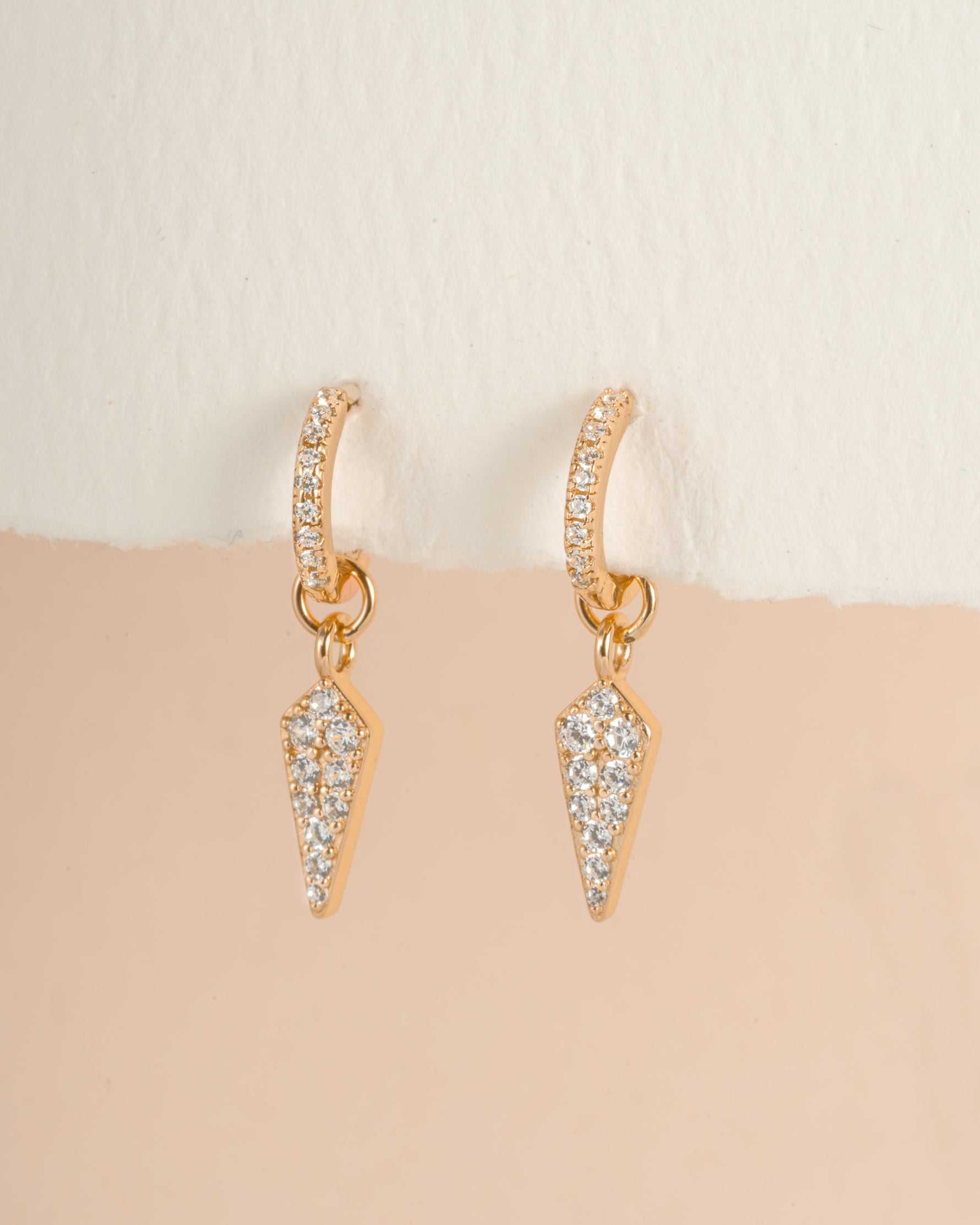 Gold Dagger Charm Huggie Earrings by Sami Jewels, close-up view showing detailed design and hoop style jewelry.