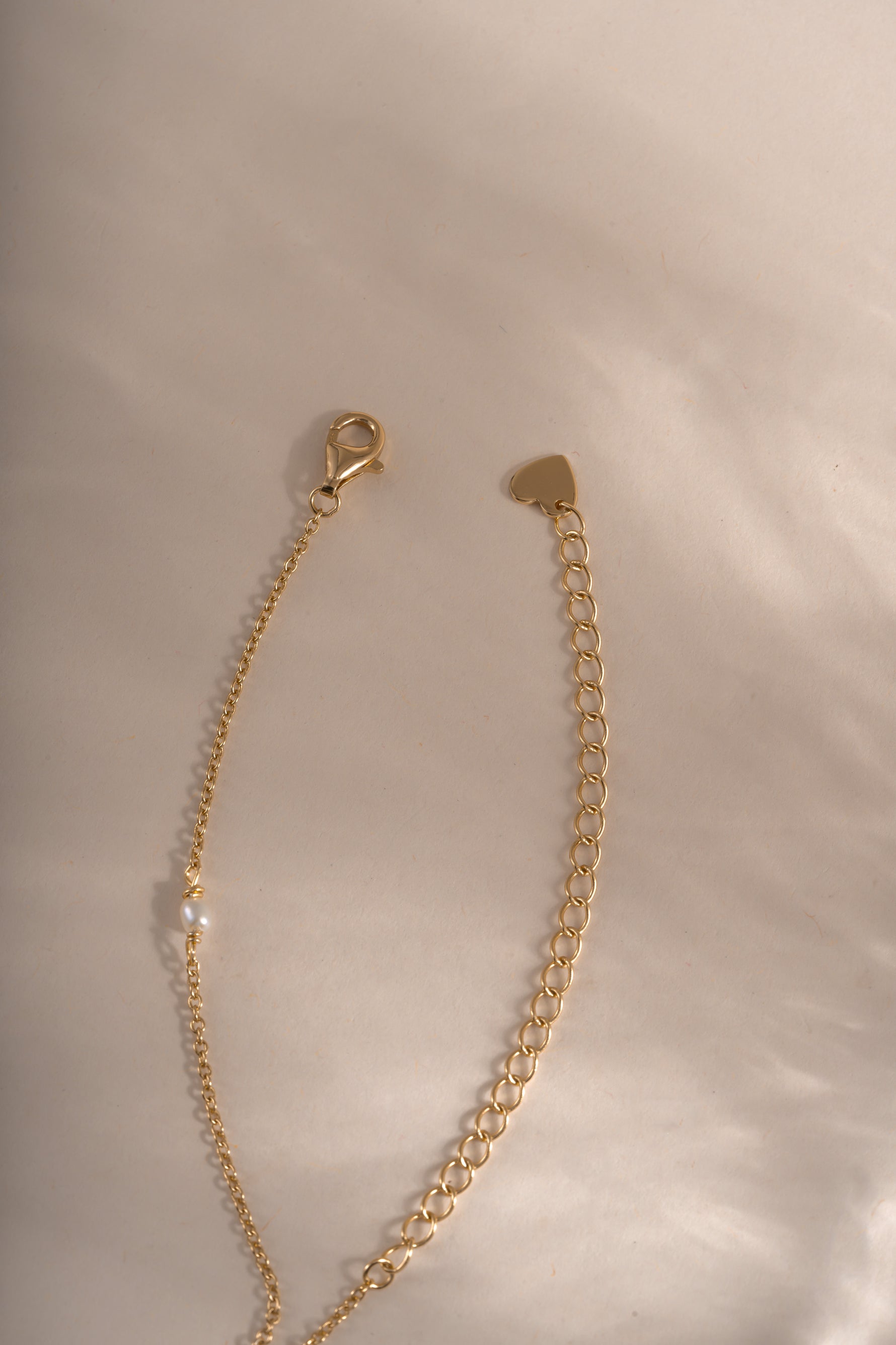 Dainty beaded pearl necklace by Sami Jewels with gold finish and lobster clasp closure, showcasing elegant jewelry design.