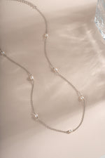 Dainty beaded pearl necklace by Sami Jewels featuring small pearls on a sterling silver chain, displayed flat.