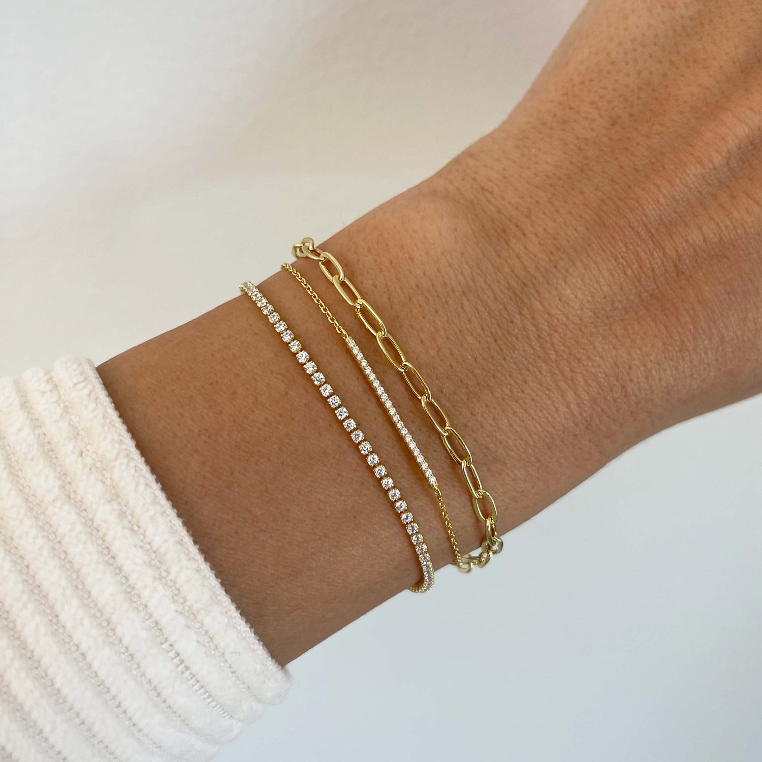model wearing dainty gold chain diamond bracelets
