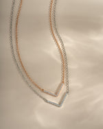 Dainty rose gold and sterling silver chevron necklace from Sami Jewels, featuring a sleek V-shaped pendant on a delicate chain.