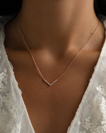 Dainty rose gold Chevron necklace from Sami Jewels worn by a model, featuring a sleek, minimalist design.