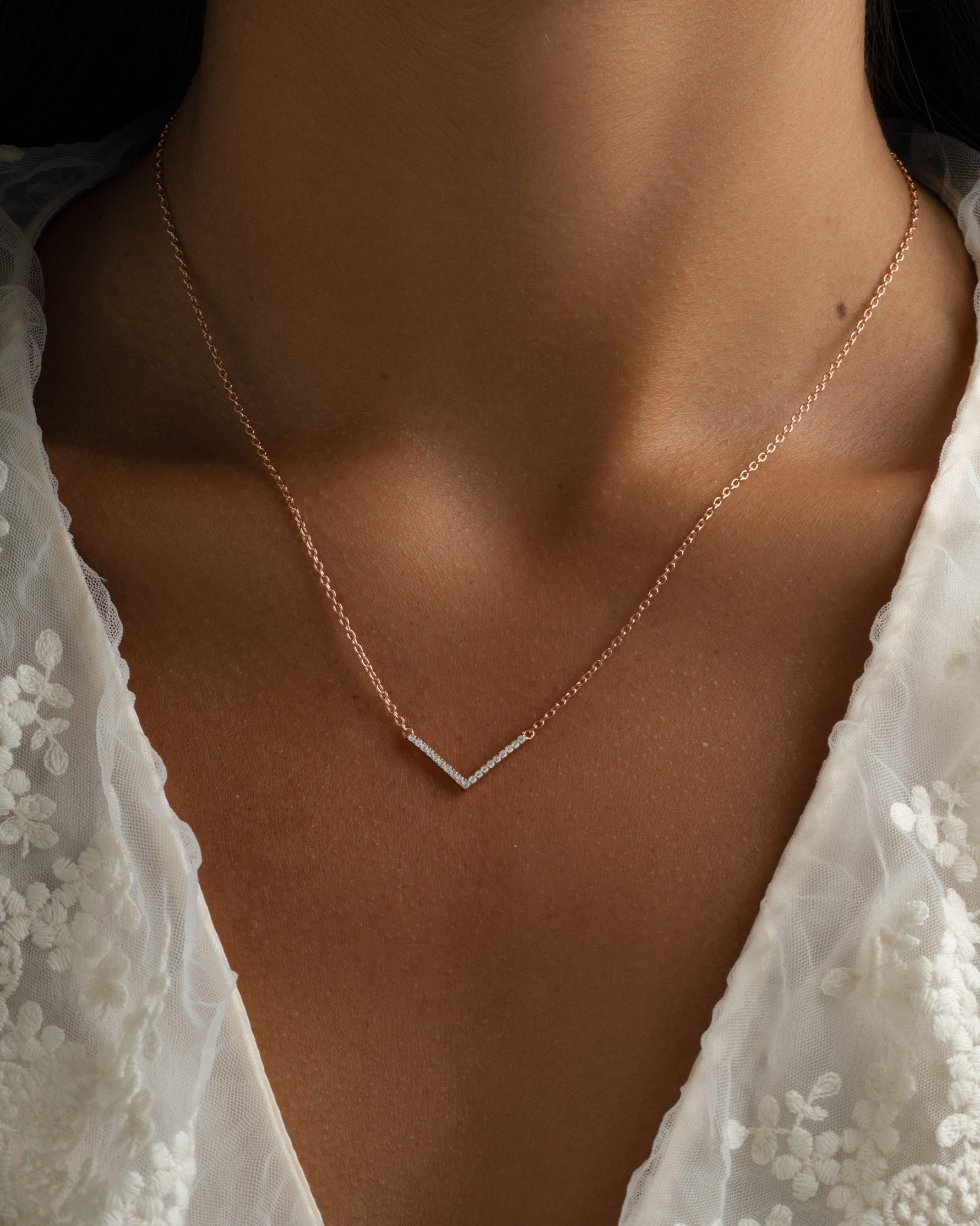 Dainty rose gold Chevron necklace from Sami Jewels worn by a model, featuring a sleek, minimalist design.