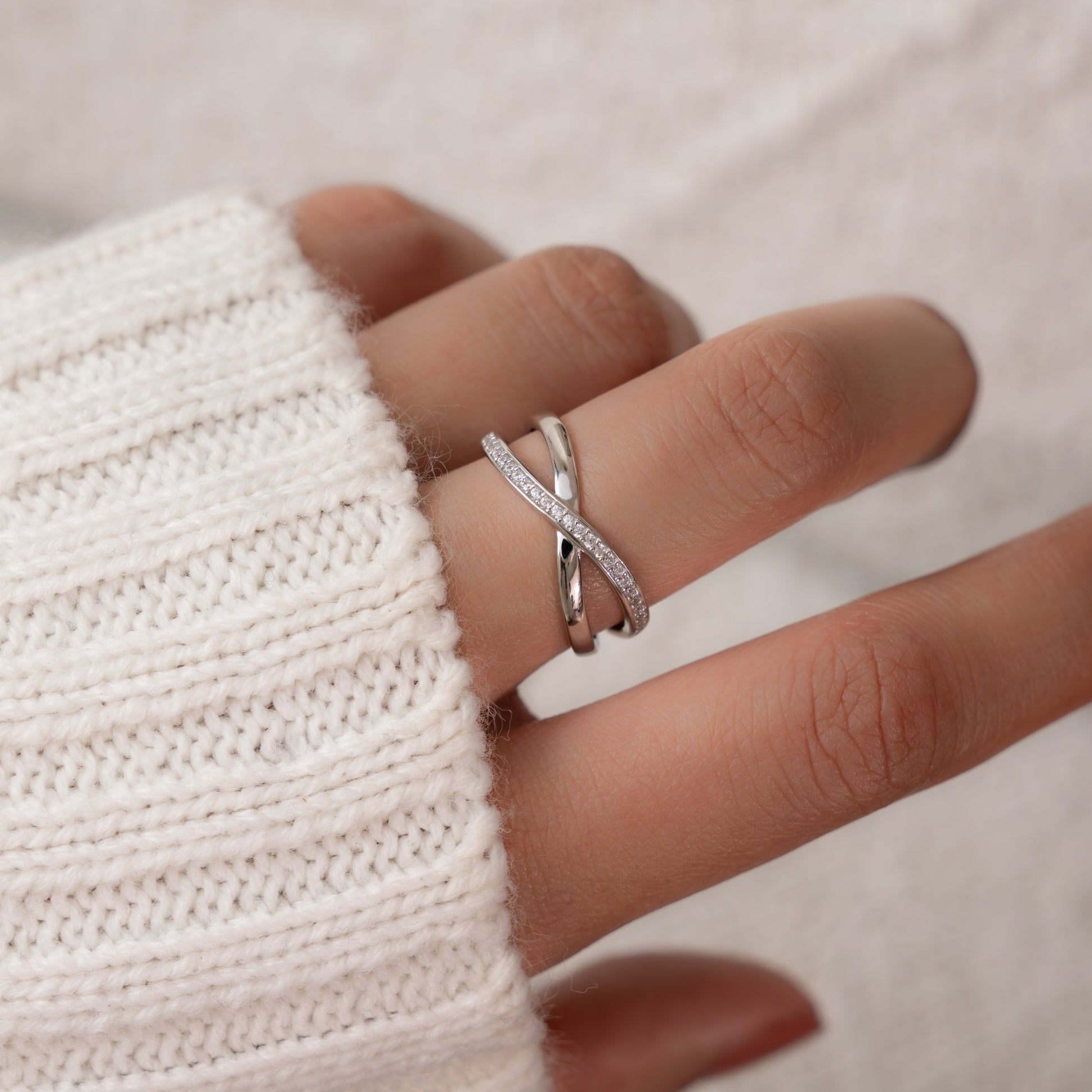 Model wearing dainty infinity ring.