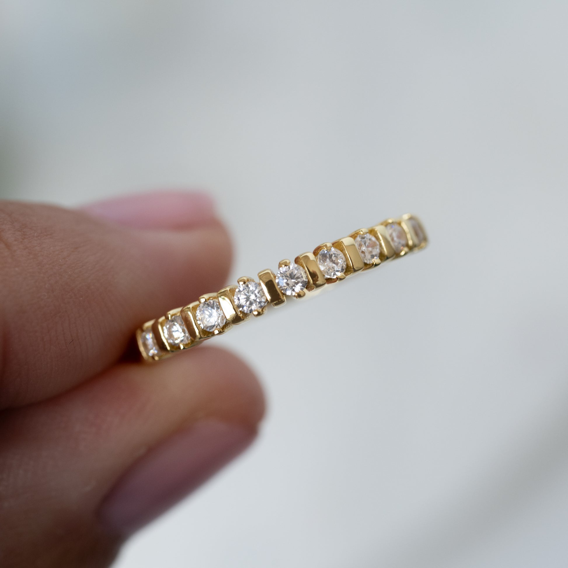 model holding gold fluted cz stacking ring