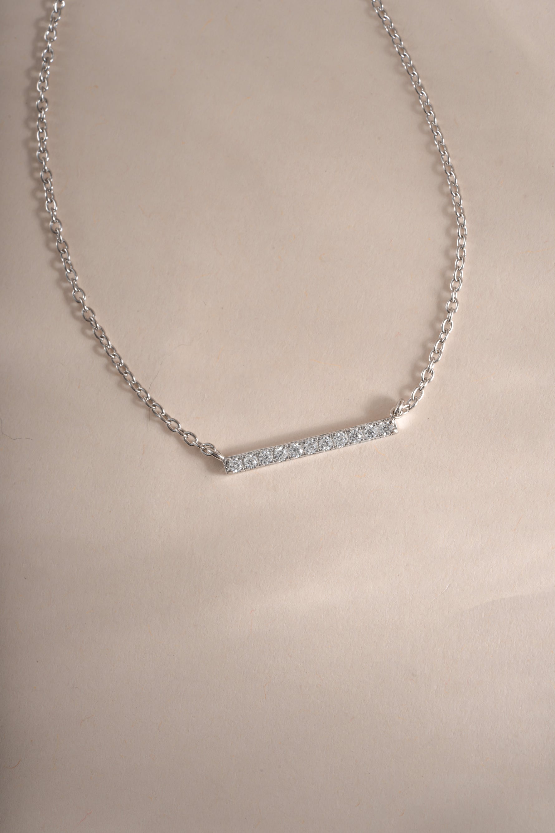Close-up of Sami Jewels dainty sterling silver bar necklace with small diamond accent, showcasing elegant minimalist jewelry design.