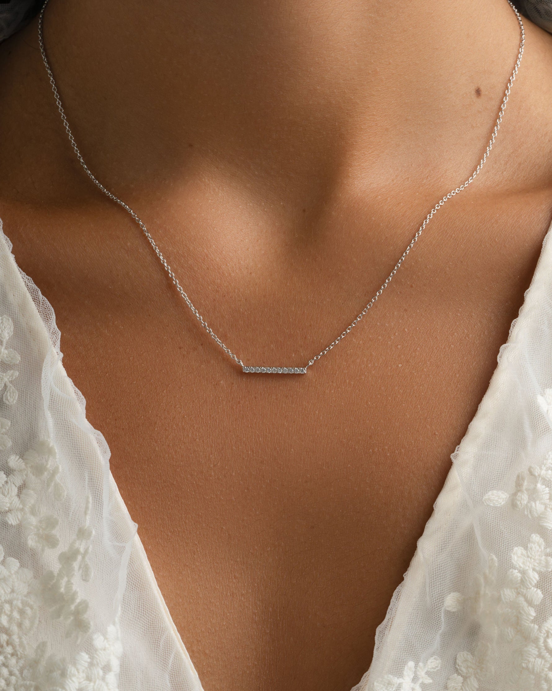 Sterling silver dainty bar necklace with diamond accent, worn by model, by Sami Jewels.