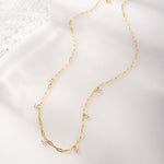 gold paperclip necklace with charms