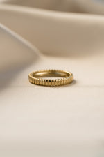 Gold dainty fluted ring from Sami Jewels featuring a sleek, textured design, shown from a front view.