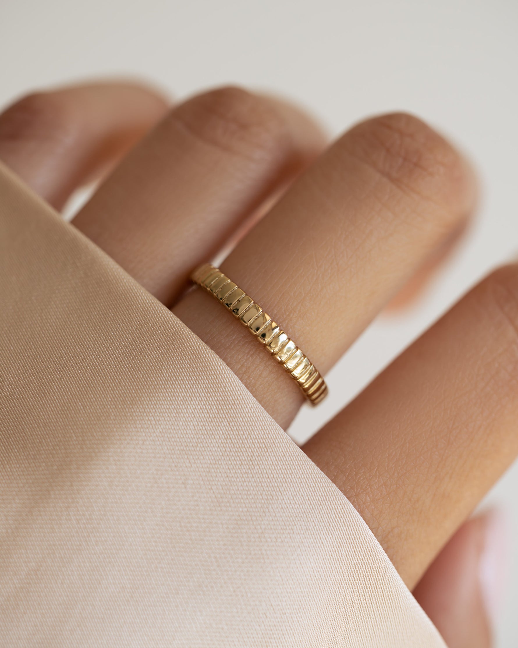 Gold Dainty Fluted Ring by Sami Jewels, close-up of the delicate ring with fluted design on a model's finger.