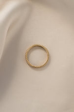 Gold dainty fluted ring from Sami Jewels, top view showing textured, slender band design.