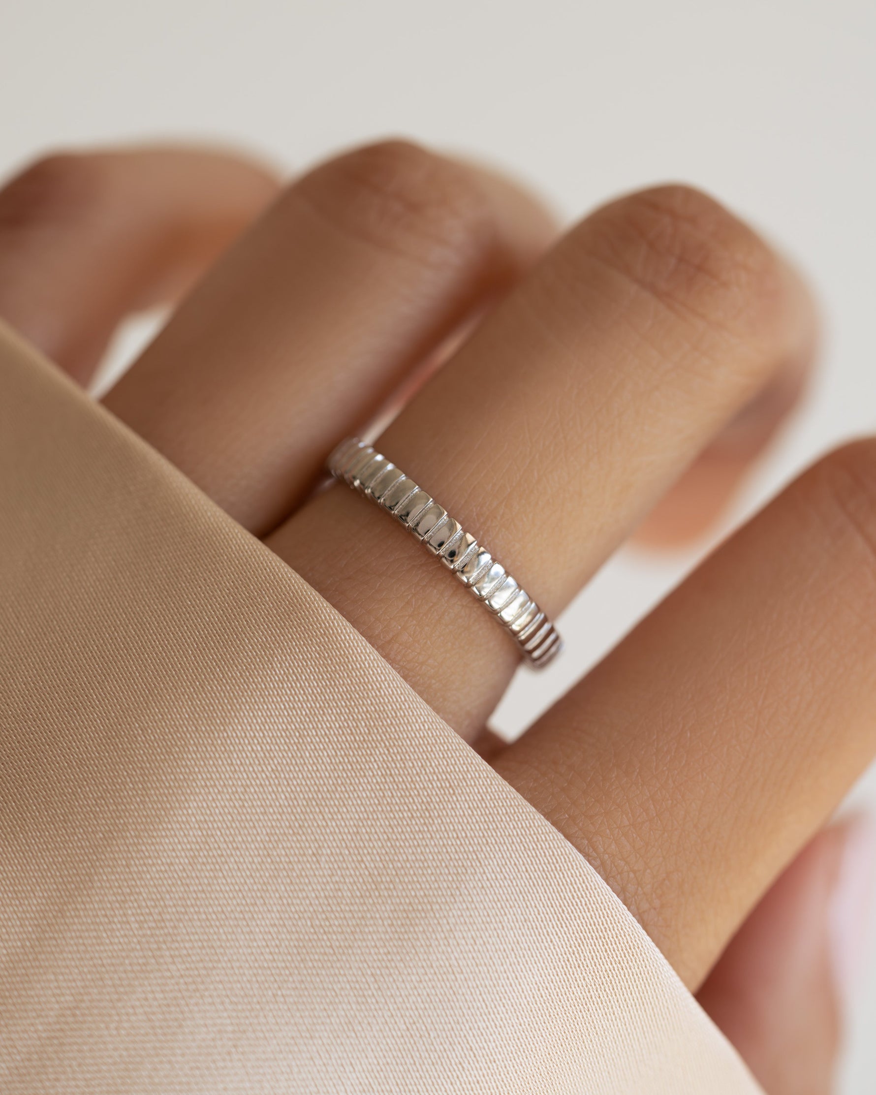 Sterling silver dainty fluted ring from Sami Jewels, showcasing a delicate, textured design on a model's finger.