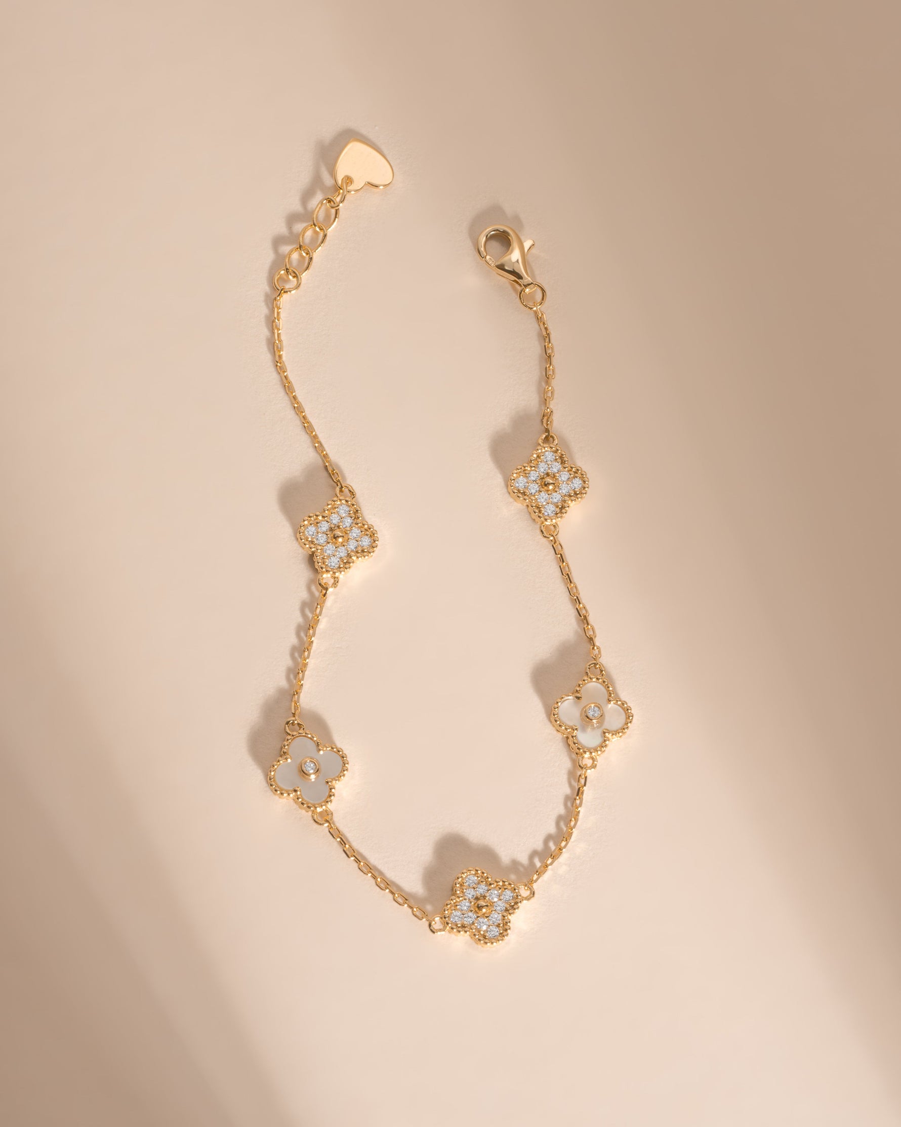 Dainty gold four-leaf clover bracelet with adjustable chain by Sami Jewels, featuring a delicate and elegant design.
