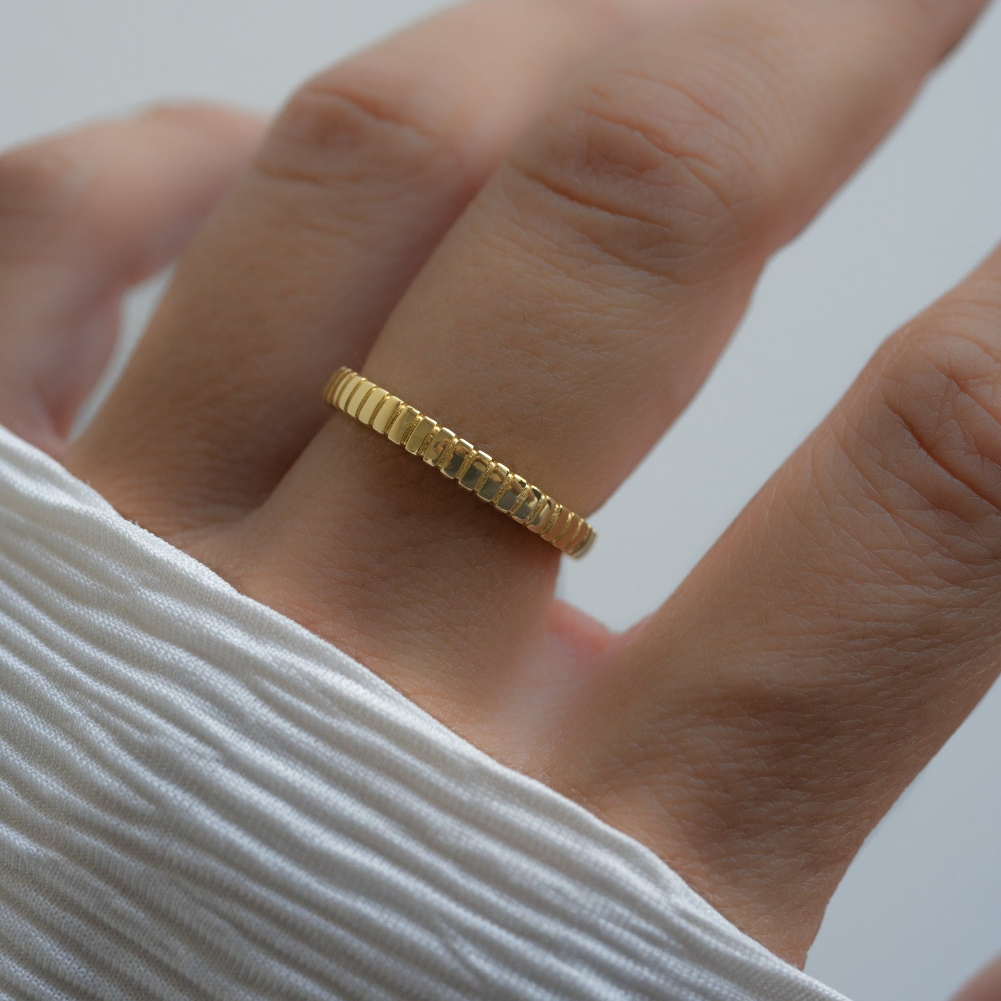 model wearing gold textured stacking ring