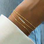 dainty bracelet set on a model 
