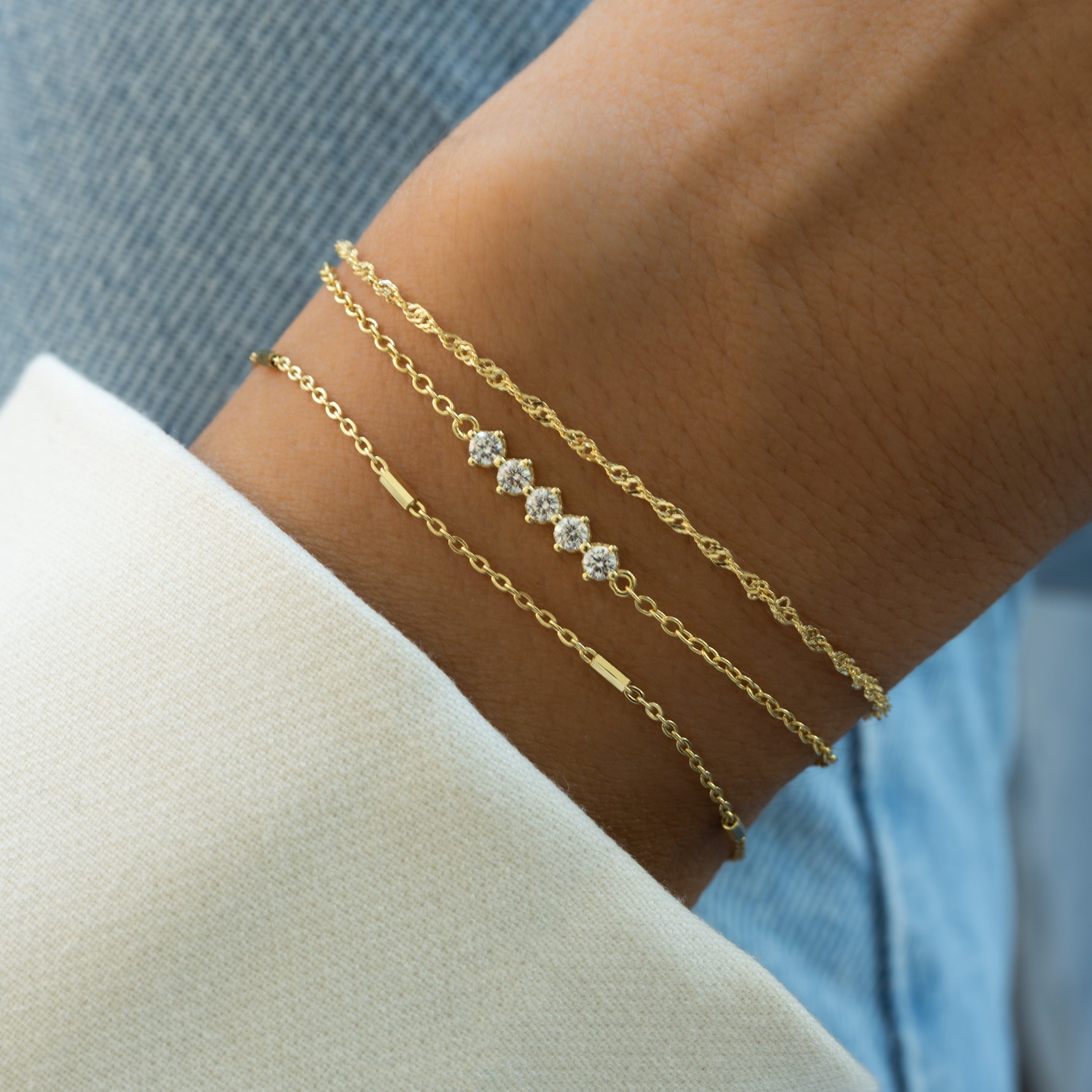 dainty bracelet set on a model 