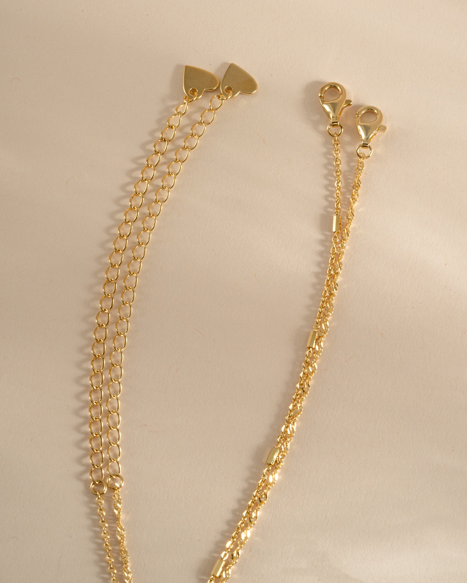 Dainty gold layering necklace set with lobster clasp closure from Sami Jewels, featuring multiple delicate chains on a white background.