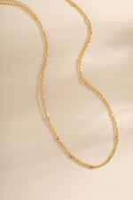 Dainty gold layering necklace set by Sami Jewels featuring multiple delicate chain necklaces on a white background.