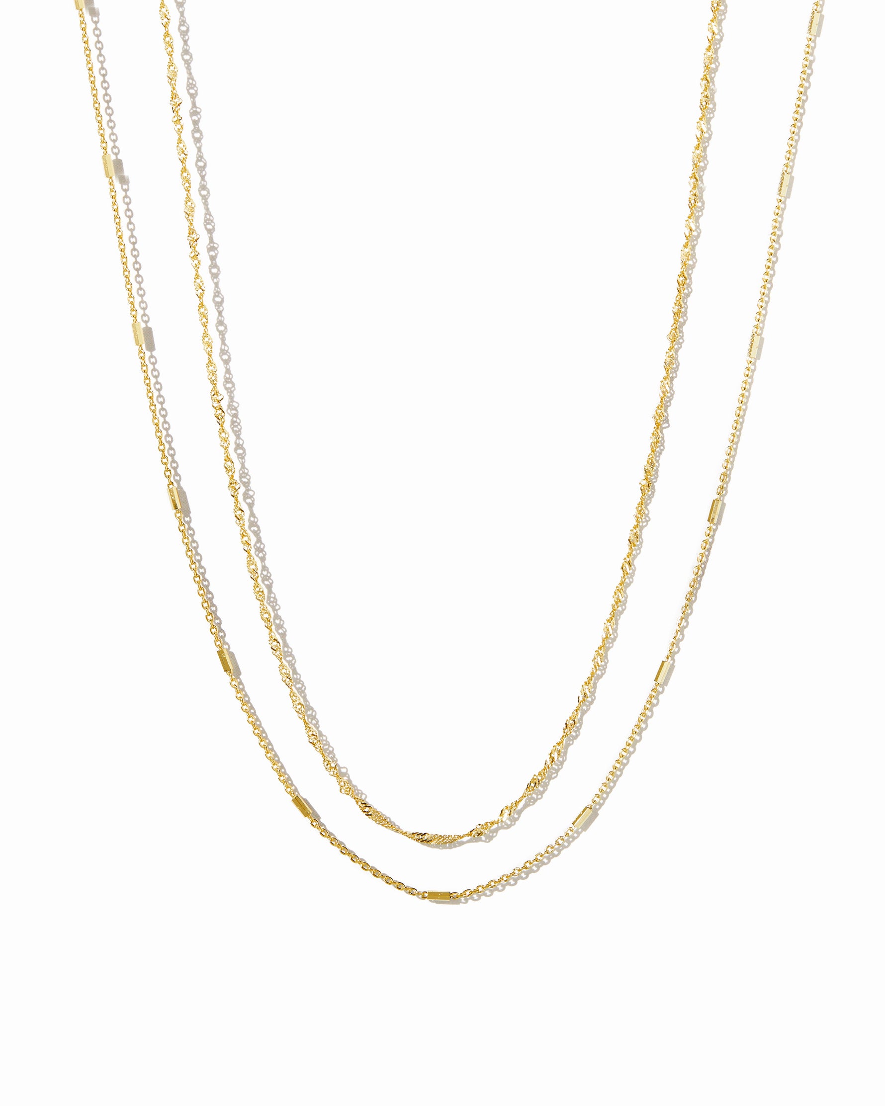 Dainty gold layering necklace set from Sami Jewels displayed against a white background.
