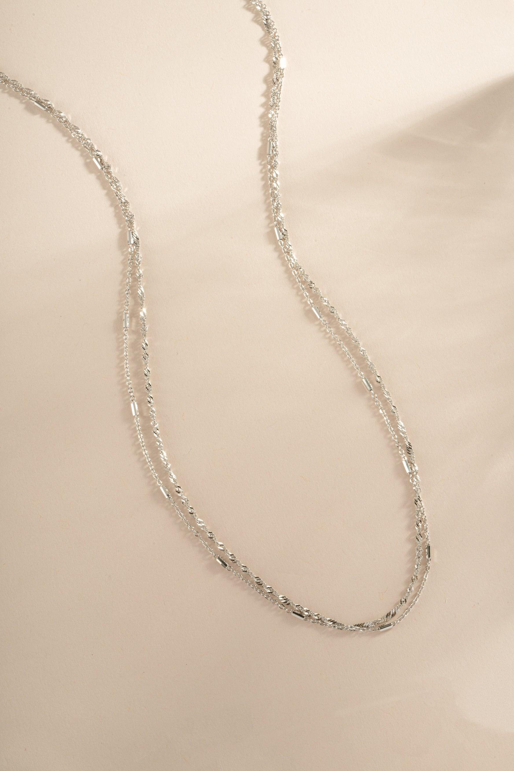 Dainty sterling silver layering necklace set by Sami Jewels featuring multiple delicate chain necklaces on a white background.