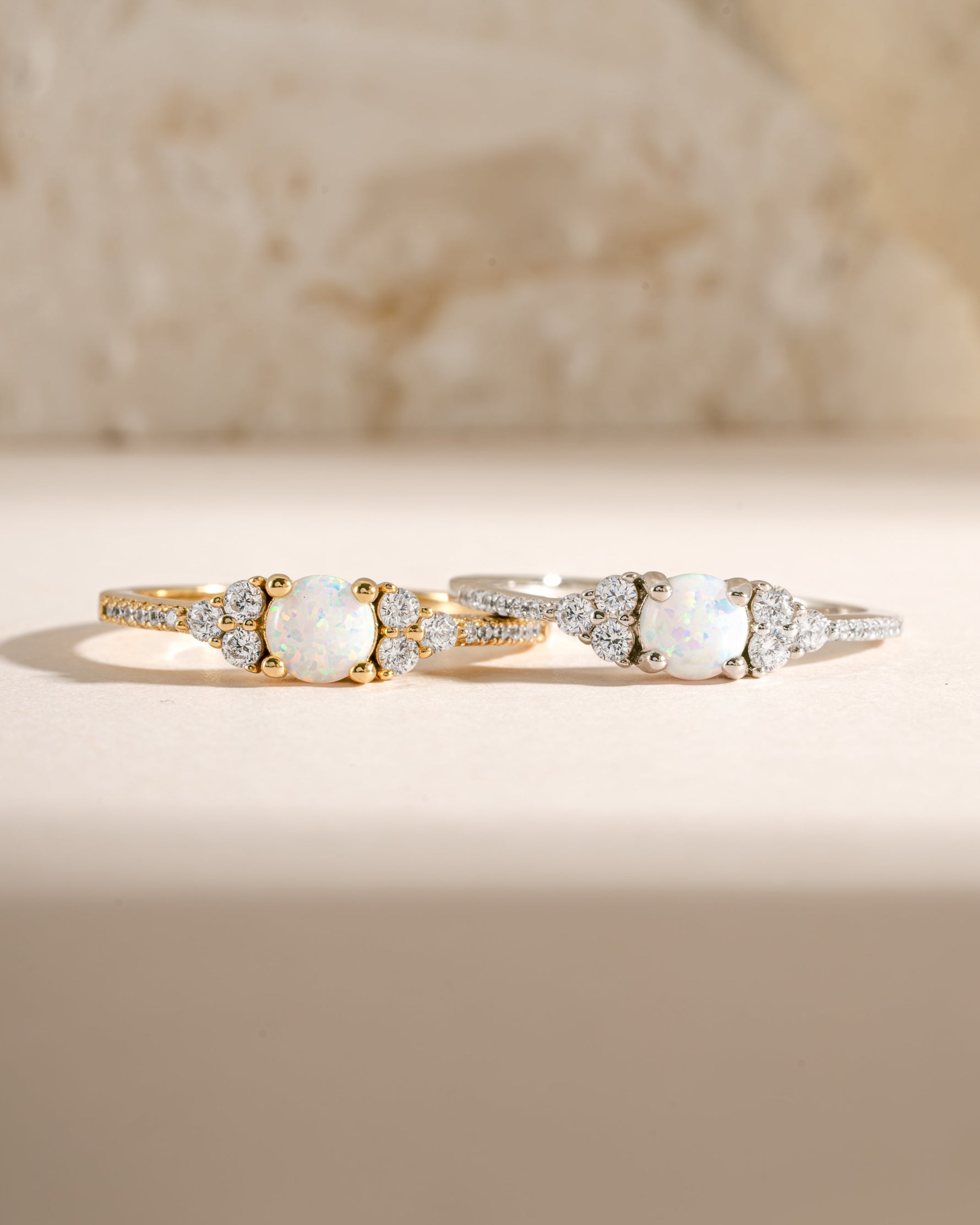 Dainty opal ring with gold and silver accents, featuring a smooth, polished opal gemstone in a delicate ring setting.