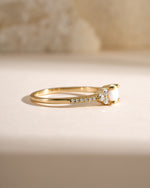 Dainty gold opal ring from Samijewels-527 shown in side view, featuring a smooth gold band and a luminous opal gemstone.