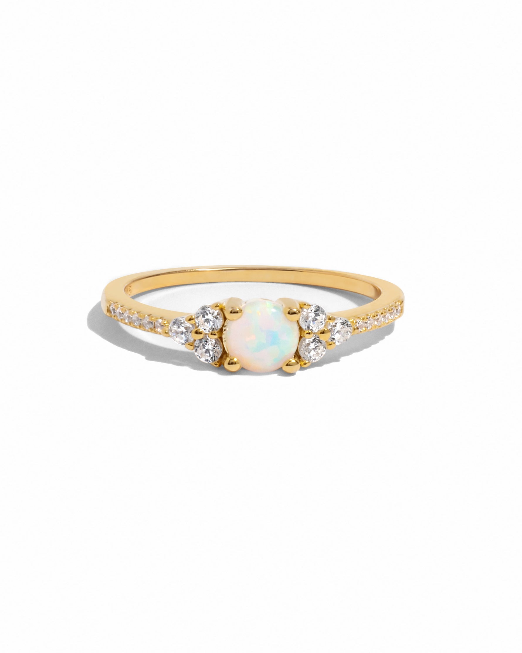 Dainty opal ring with gold band from Samijewels-527, showcasing a smooth white opal gemstone on a plain white background.