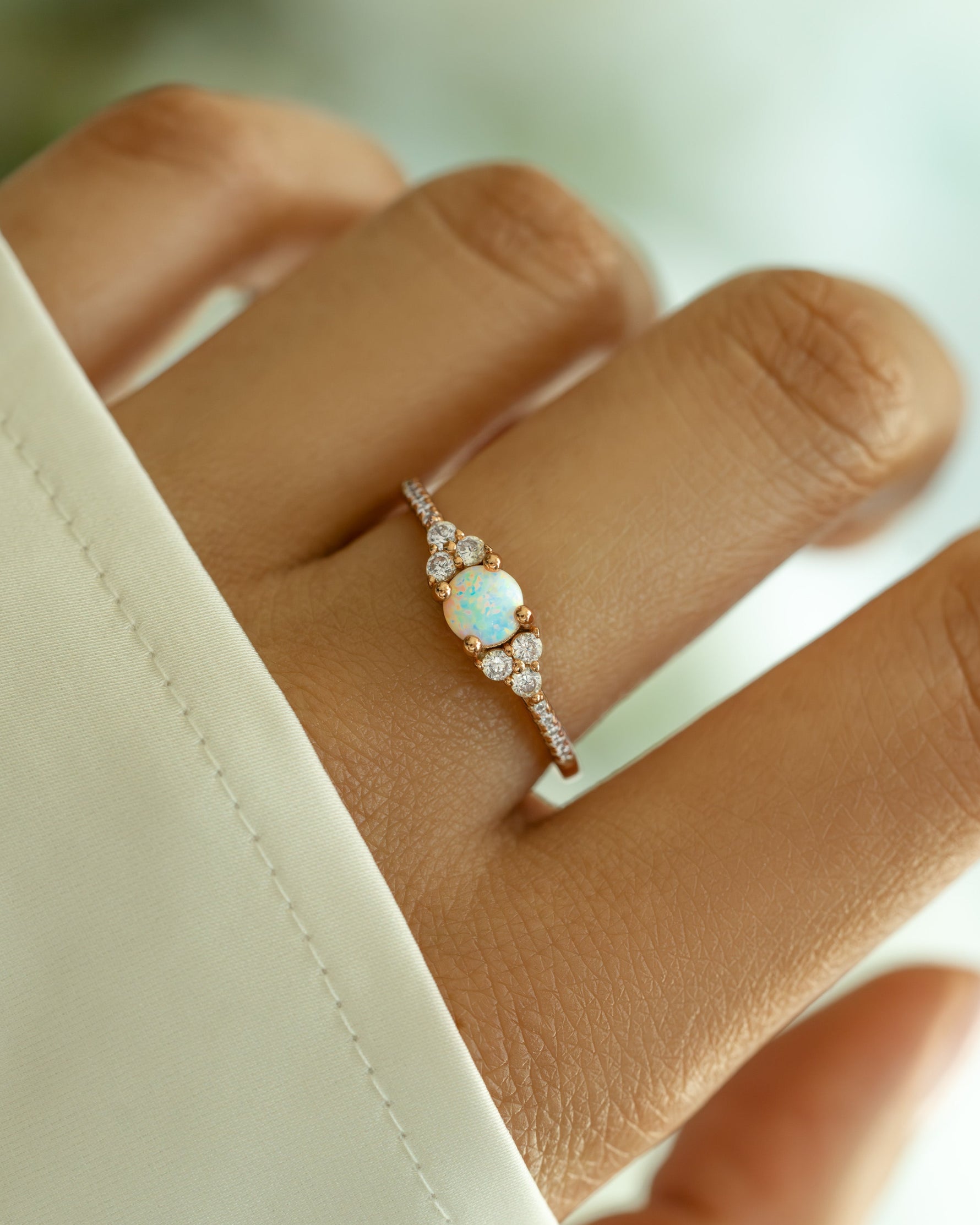 Dainty opal ring in rose gold with a smooth, polished band, showcasing a delicate opal gemstone setting.