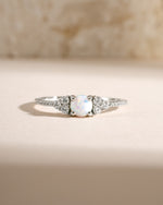 Close-up of Samijewels-527 dainty silver opal ring showcasing a smooth, polished opal gemstone on a delicate band.