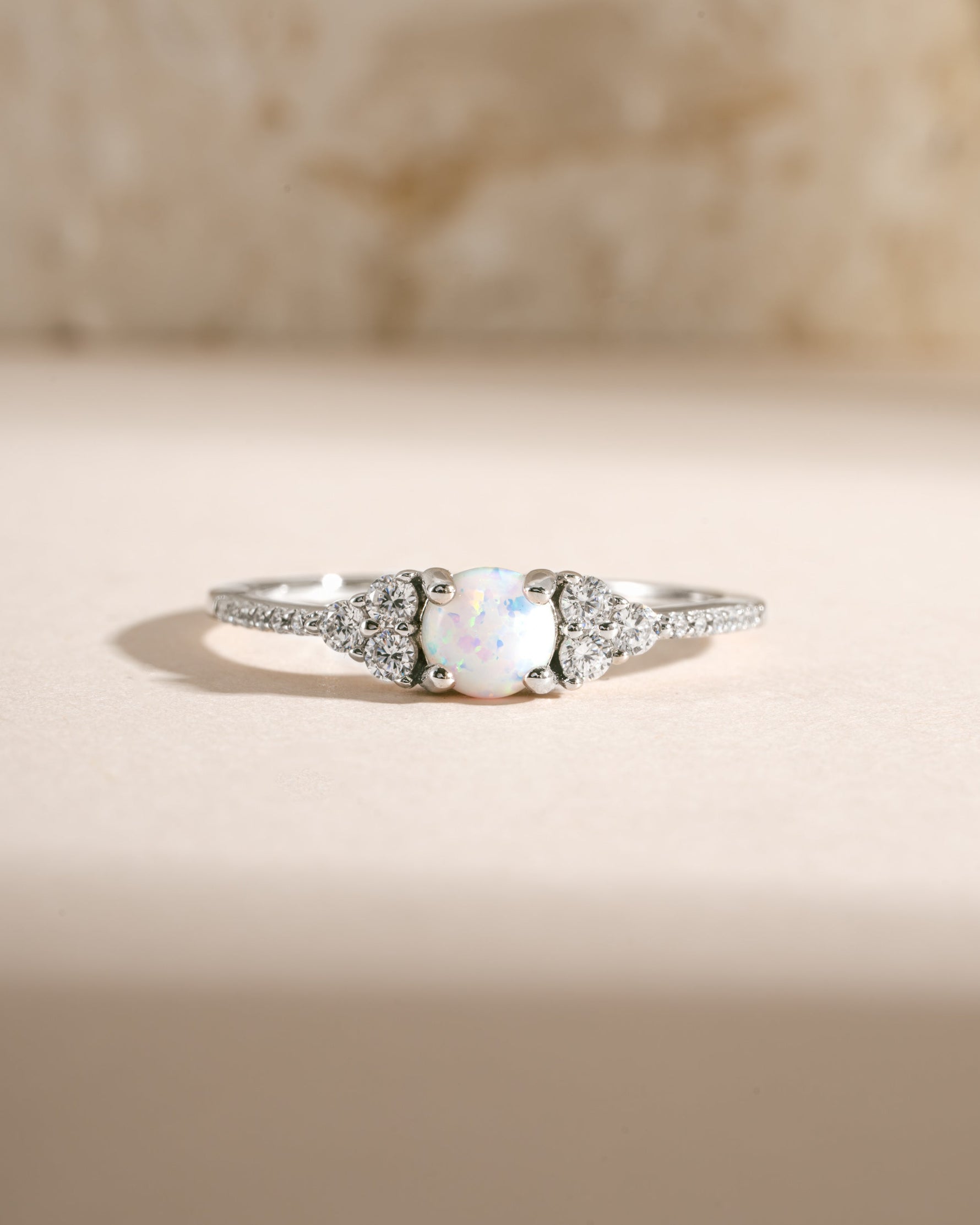 Close-up of Samijewels-527 dainty silver opal ring showcasing a smooth, polished opal gemstone on a delicate band.