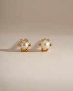 Gold dainty pearl stud earrings by Sami Jewels featuring small, round pearls on classic stud settings, front view.