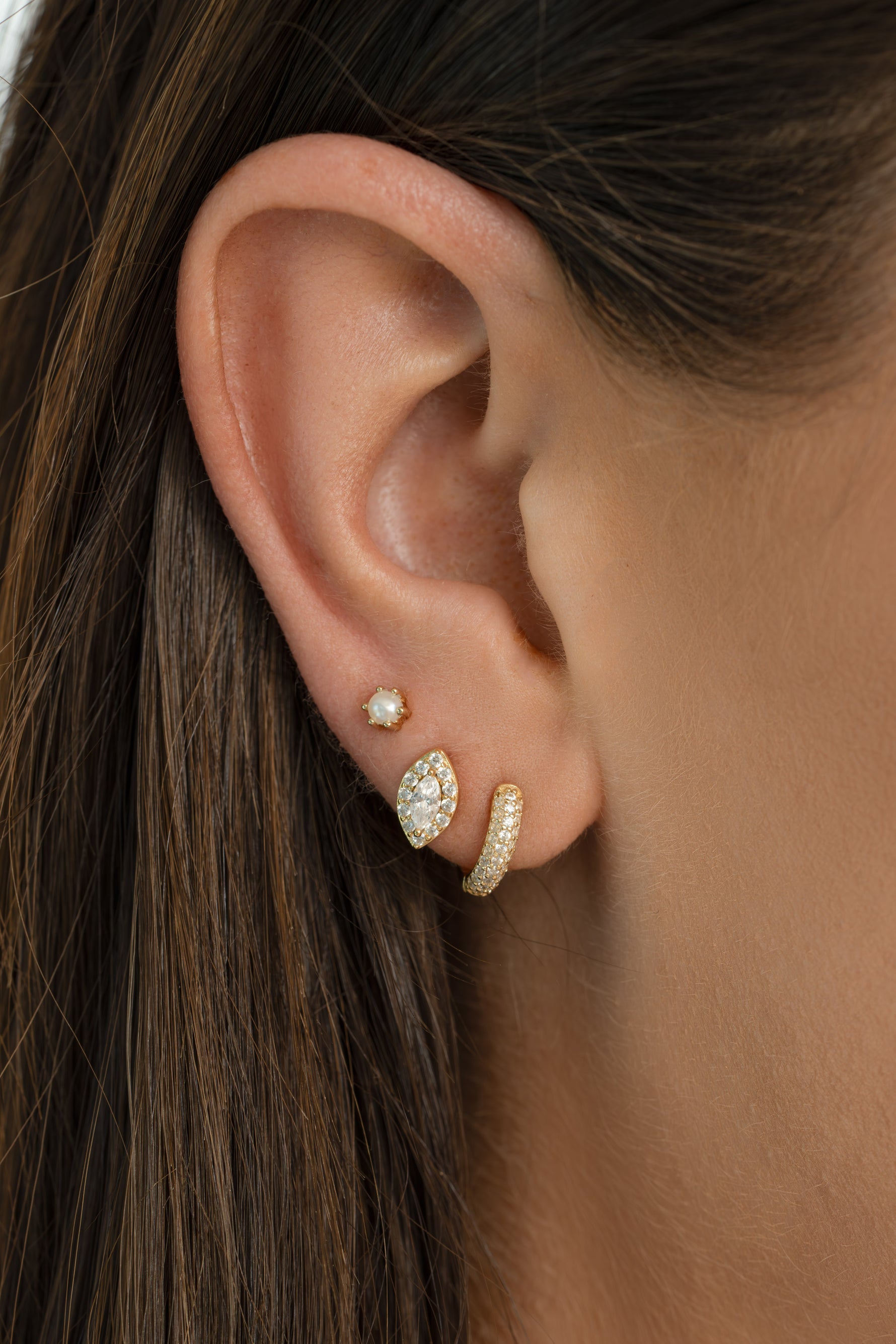 Dainty pearl stud earrings by Sami Jewels featuring small, elegant white pearls on gold studs for a classic jewelry look.